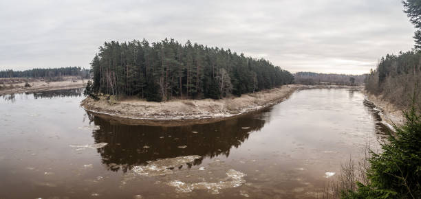 istock Beautiful river bend and forest on a winter day 1321251849