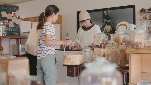 WS- Japanese woman at the cashier in a zero waste bulk shop