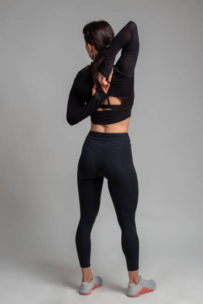 istock Flexible girl doing stretching workout on grey background 1321252861