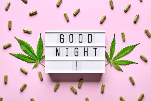 cannabis extract capsules, hemp leaves and good night letters lightbox. calming, anti-stress and sleeping concept - narcotic medicine pill insomnia imagens e fotografias de stock