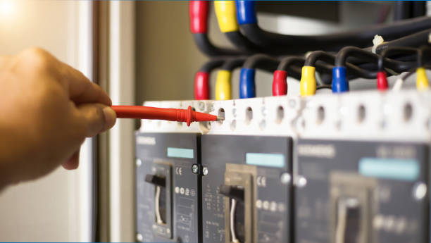 istock Electrician engineer work tester measuring voltage and current of power electric line in electical cabinet control. 1321257253