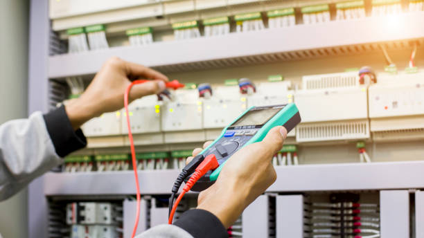 istock Electrical engineer tests the operation of the electric control cabinet on a regular basis for maintenance. 1321257339