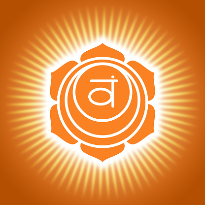 Chakra swadhisthana. Orange shining yoga symbol. Om sign. Sacral icon