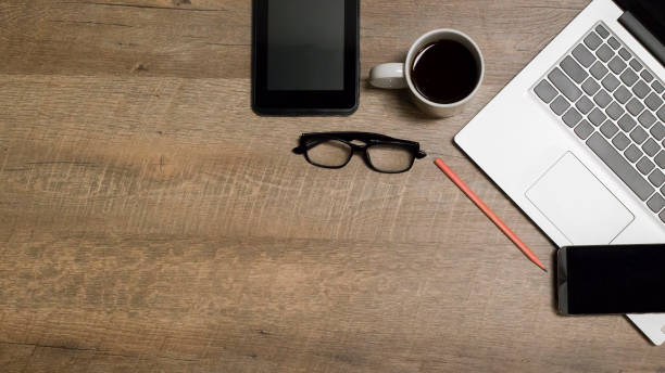 istock Notebook, coffee cup, glasses, pencil, on a wooden background. 1321257623