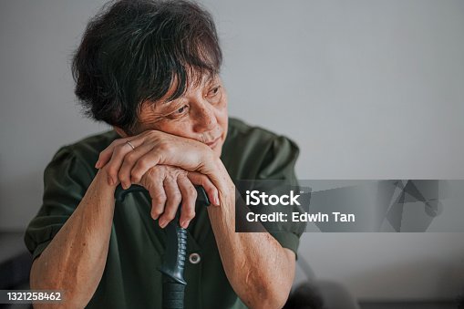 istock sad asian chinese senior woman at home portrait 1321258462