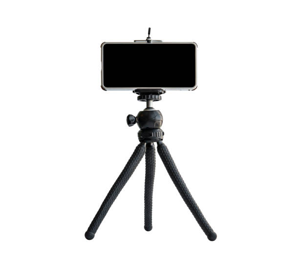 istock Smart Phone isolated on tripod in white background. blank black screen. copyspace 1321258516