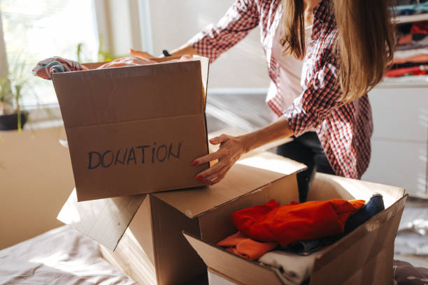 istock Woman preparing clothes for donation at home 1321261647