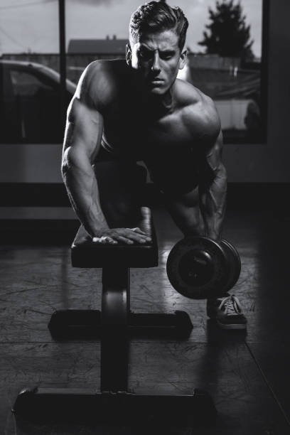 istock Muscular Man Working Out In Gym 1321263382