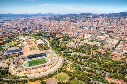 May 8, 2021 - Barcelona, Spain: Aerial view of the anella olimpica (olympic ring) and the Park of Montjuic in Montjuic mountain, and cityscape of Barcelona