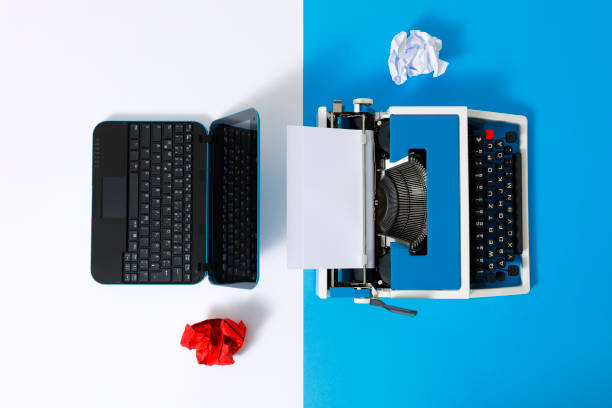 istock Digital und analog – Laptop and 80s Typewriter 1321267650