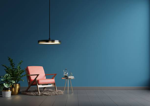 istock Interior wall mockup in blue tones with red leather armchair on dark wall background. 1321269739