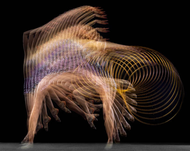 retrato de joven gimnasta rítmica en movimiento y acción aislada en luz mixta sobre fondo oscuro. - stroboscopic image fotografías e imágenes de stock