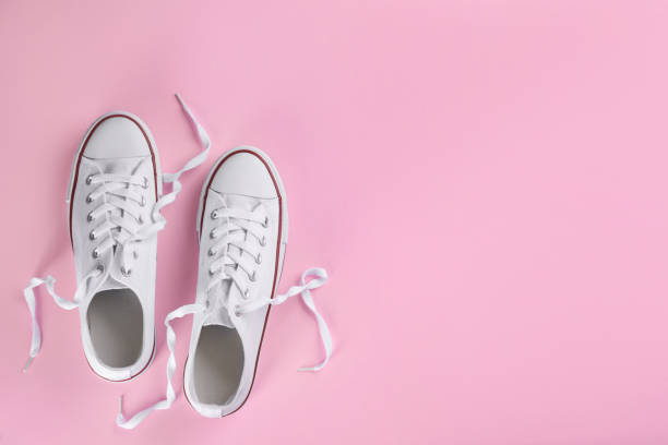 istock Pair of trendy sneakers on pink background, flat lay. Space for text 1321271117