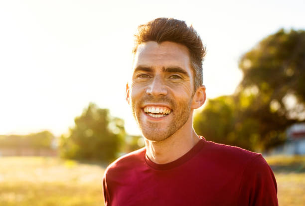 istock Young man laughing while standing outside on a sunny afternoon 1321271210