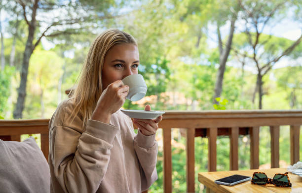 istock Woman Drinking Coffee on Terrace 1321271305