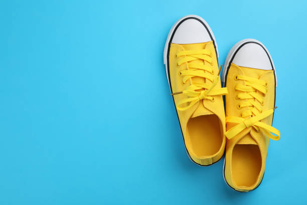istock Pair of trendy sneakers on light blue background, flat lay. Space for text 1321271315