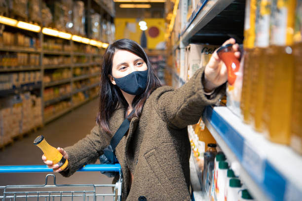 istock woman choosing juice at grocery store 1321274149