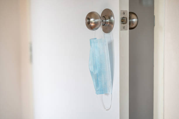 istock Used protective face mask hanging on the wall 1321276244