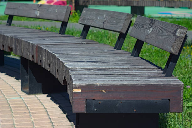 istock half-circle wooden bench in the walking area 1321276528