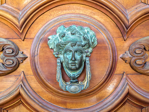 Door knocker like antique head on the entrance of a house on Malta.