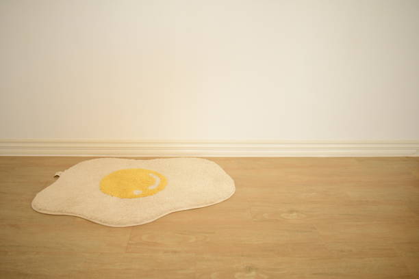 istock cute white fried egg floor mat on muji minimal style room white and warm mood background 1321277667
