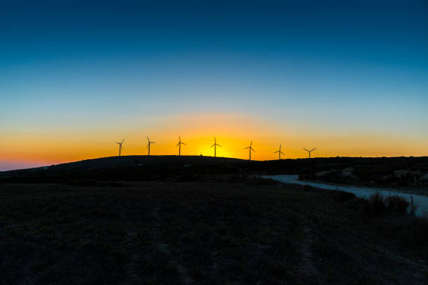 istock Windmills in a sundown dune landscape. 1321278026