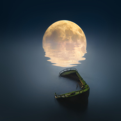 Scenic view of small fishing boat in calm sea water at night and full moon.