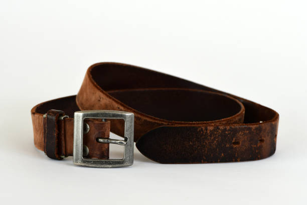 istock Old leather belt isolated on white background. 1321280765