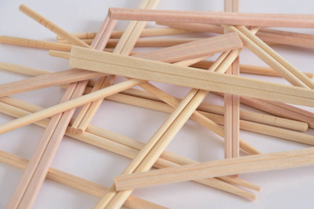 istock Disposable wooden chopsticks on white background. 1321280859
