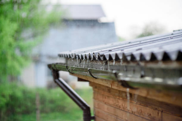 istock Rain water falling down from house roof in rainy season. 1321286800