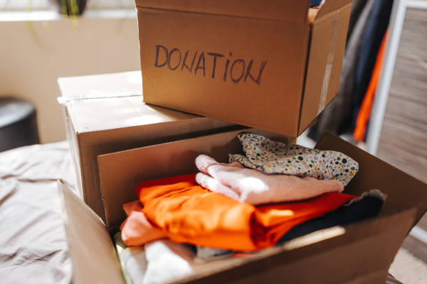 istock Boxes with clothes for donation in home interior 1321288196