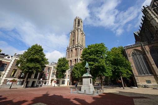 Utrecht, the Netherlands - July 23, 2017:  The Gothic-style Dom tower is the most prominent building in Utrecht and the tallest church tower in the Netherlands, at 112.5 metres (368 feet) in height. It is the symbol of the city.