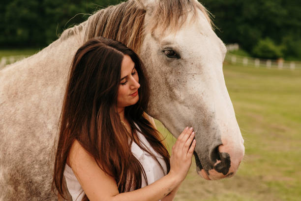istock Young woman stroking a horse 1321290884
