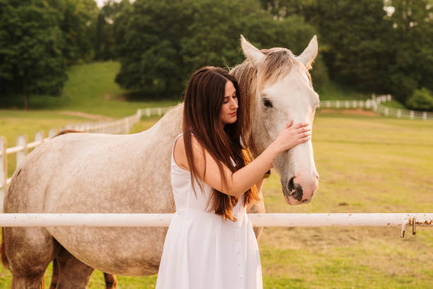 istock Young woman stroking a horse 1321291056