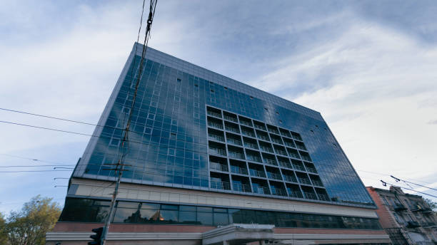 istock Multi-storey business center with many windows against the blue sky. 1321291243