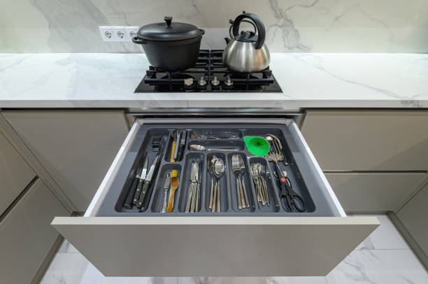 istock Open drawer with cutlery at modern white woden kitchen in classic style 1321291389