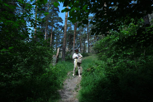istock Mature woman is going to exercise using resistance band in natural park 1321291435