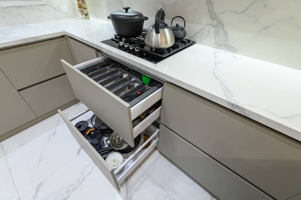 istock Open drawer with cutlery at modern white woden kitchen in classic style 1321291437