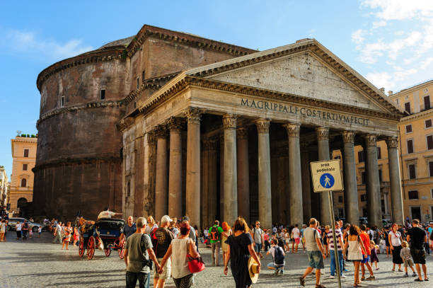 istock Ancient pantheon exterior daytime with crowded square in Rome, Italy 1321292840