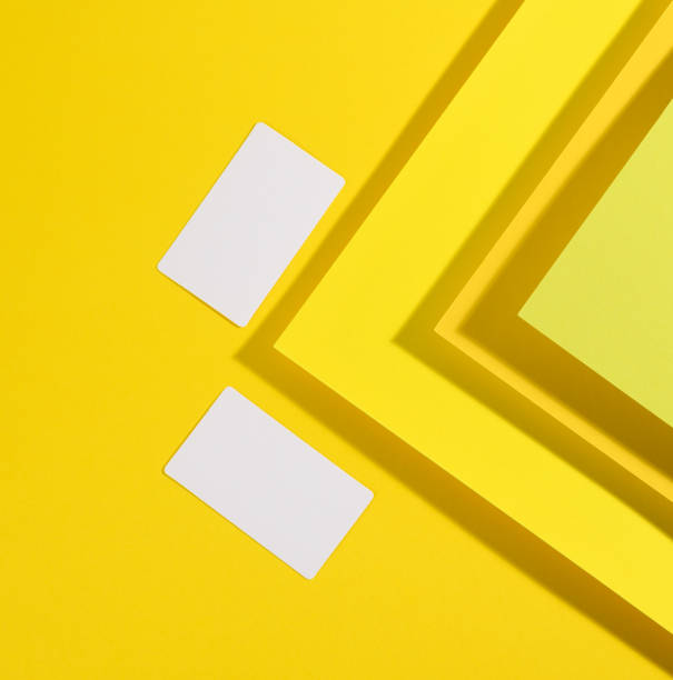 istock blank white rectangular business card on creative yellow background from sheets of paper with shadow 1321294764