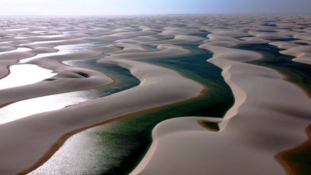 Lencois Maranhenses National Park, Maranhao, Brazil. Sand dunes and rainwater lakes landscape. Lencois Maranhenses National Park, Maranhao, Brazil. Sunset at sandy mountains of Lencois Maranhenses. Barreirinhas, Maranhao, Brazil. Tropical scenery vacations on exotic destination. Lençois Maranhenses National Park, Maranhao, Brazil. Sand dunes and rainwater lakes landscape. Brazil Northeast. brazil desert maranhao state national park stock pictures, royalty-free photos & images