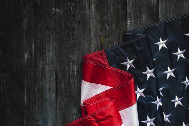 istock USA Flag on dark wooden background 1321296267