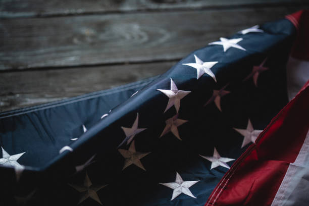 istock USA Flag on dark wooden background 1321296327