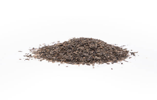 istock Dry black tea leaves isolated on white background. 1321296944