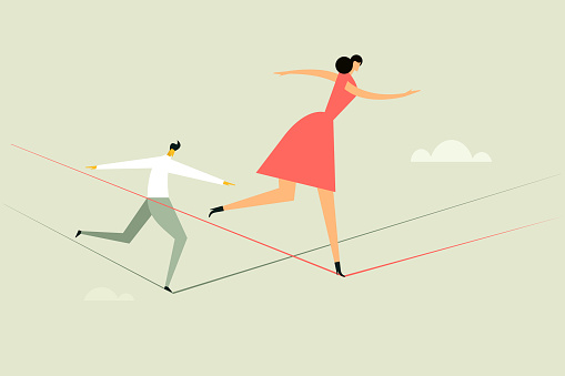 A woman and a man walking on a tight rope. Concept for moving ahead with risks and challenges