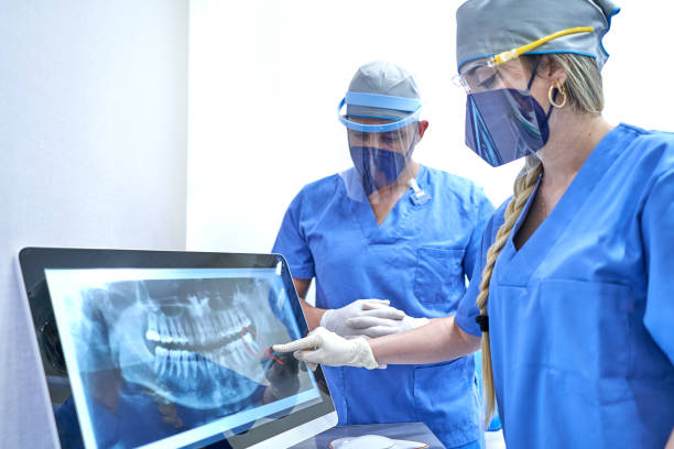 Dentist teaching his medical team an X-ray stock photo
