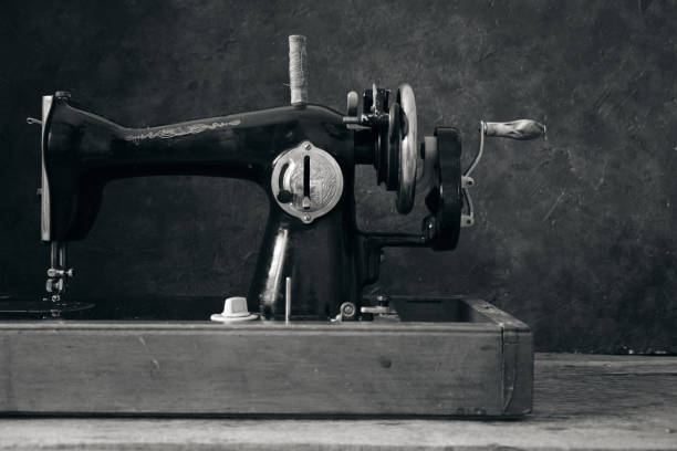 istock Old, retro, vintage sewing machine on a dark background of an abstract wall. 1321298047