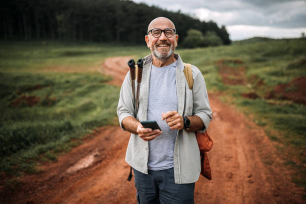 It's time to go up Active senior man hiking in nature 55 59 years stock pictures, royalty-free photos & images