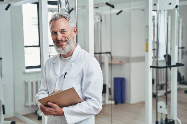 istock Contented physiatrist with a clipboard in his hand looking ahead 1321298549