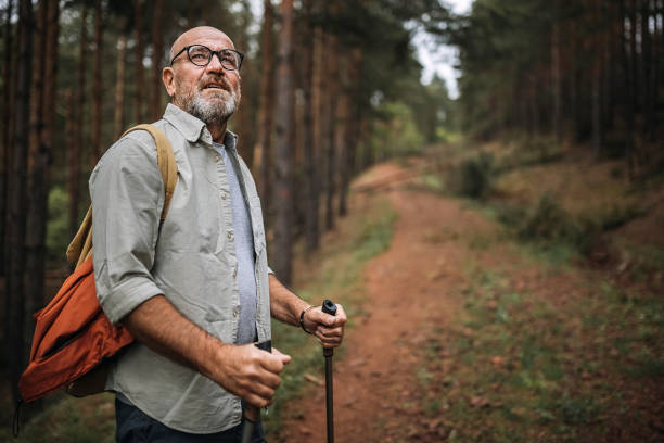 istock Senior man hiking on mountain with use of hiking pole 1321299448
